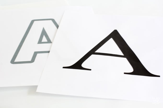 Two letter A printed out using different fonts showing which is better when making button letter art.