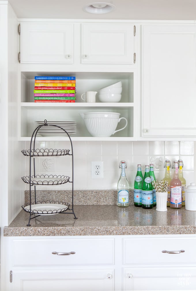 Granite Transformations countertops in Perla di Modena below a section in where  kitchen cabinet doors were removed to create open shelving.