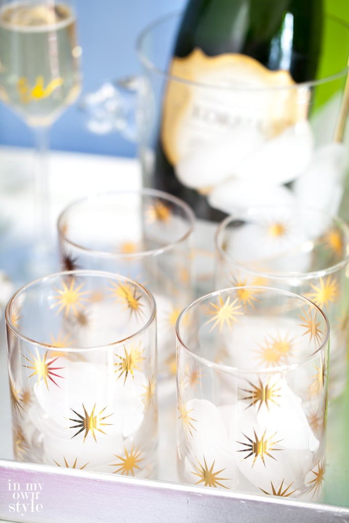 New Years Eve Barware on tray with a bottle of champagne in the background.