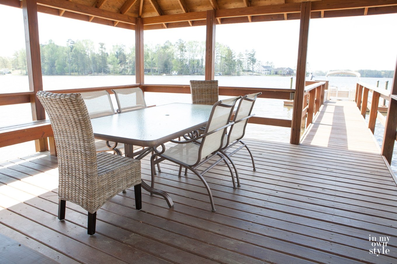 lake house gazebo with painted metal furniture on it