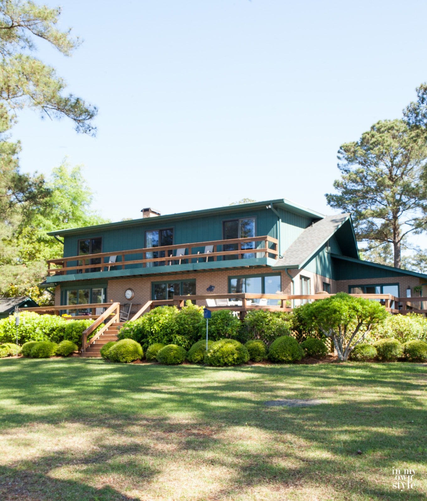 Faded teal paint on brick lake house that got a makeover.