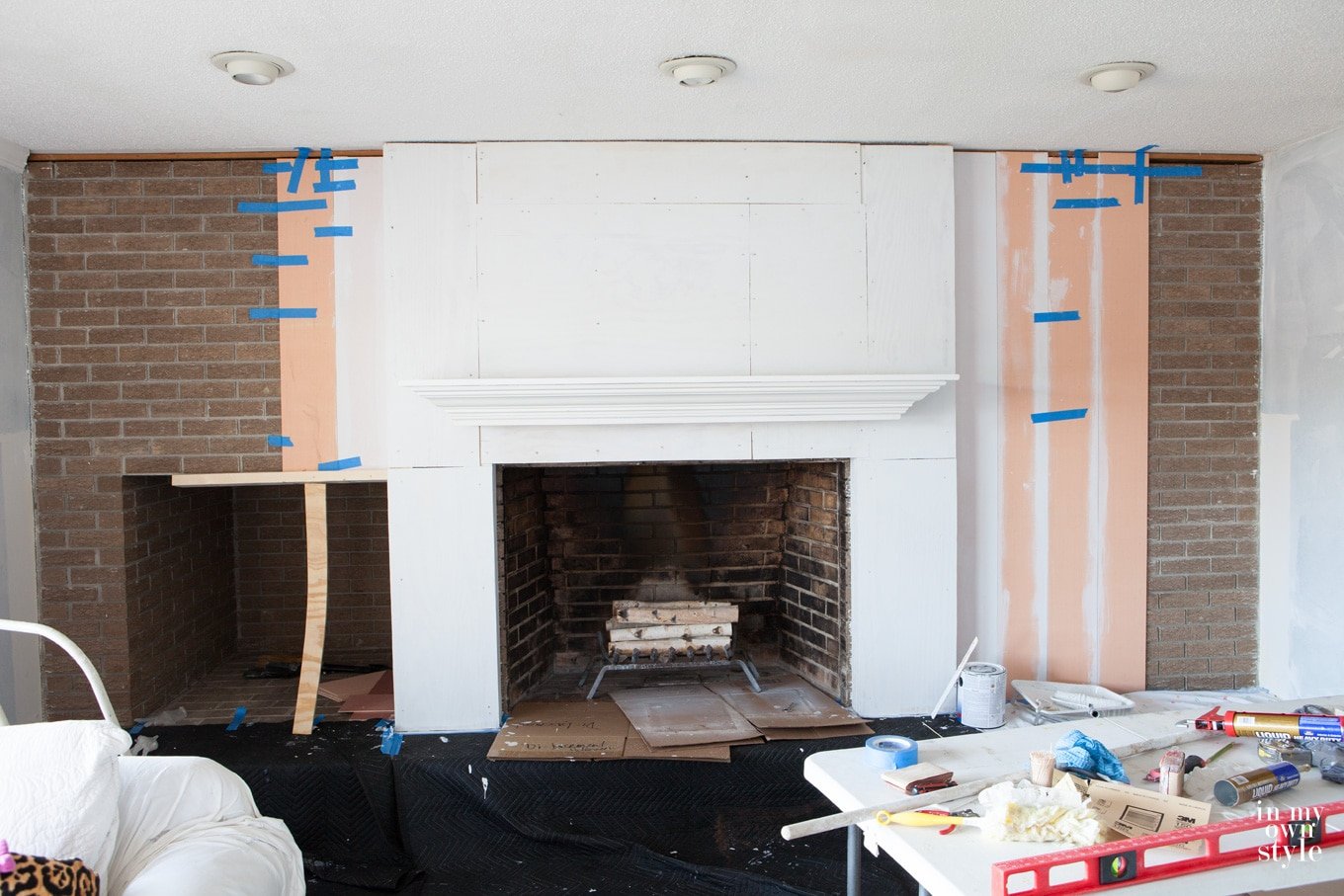 Brick fireplace wall makeover using vertical wood planking
