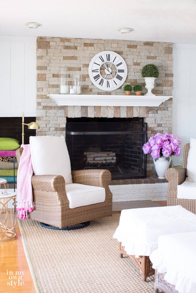 Airstone Fireplace makeover with wicker chairs in front.