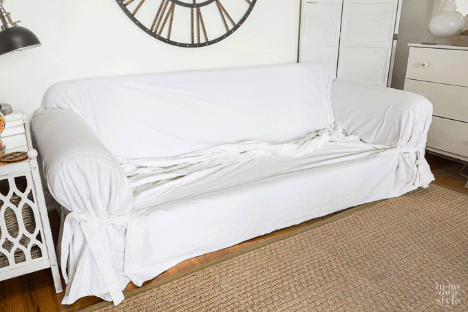 How to easily put a throw style slipcover from Pottery Barn on a sofa