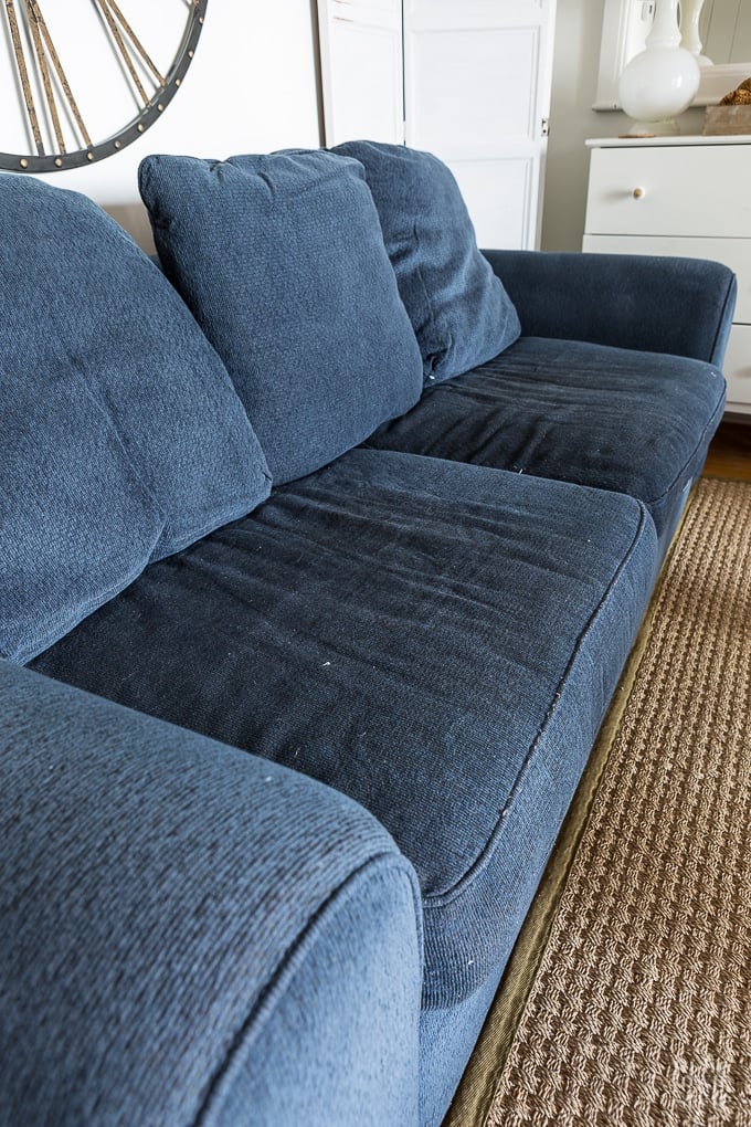 How to cover a sofa using a white loose fitting slipcover