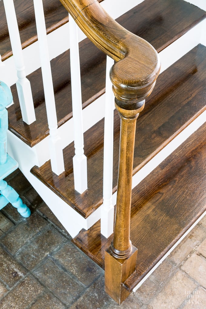 stained newel post with white balusters