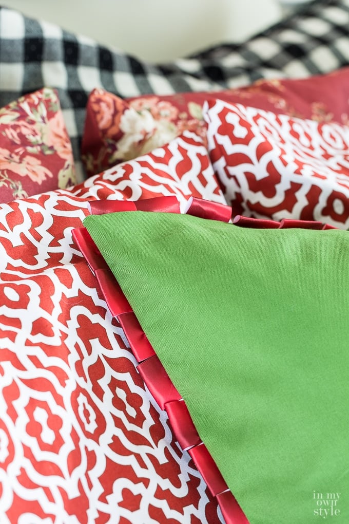 DIY looped satin ribbon edge pillow on bed.