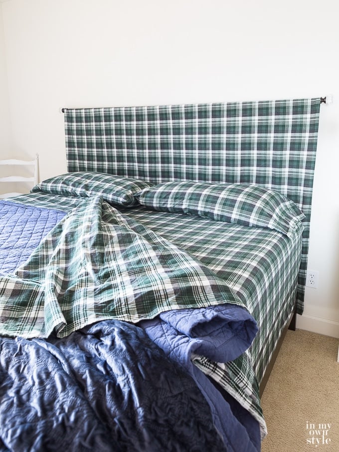 box spring and mattress both covered with fitted sheets for a decorated look.
