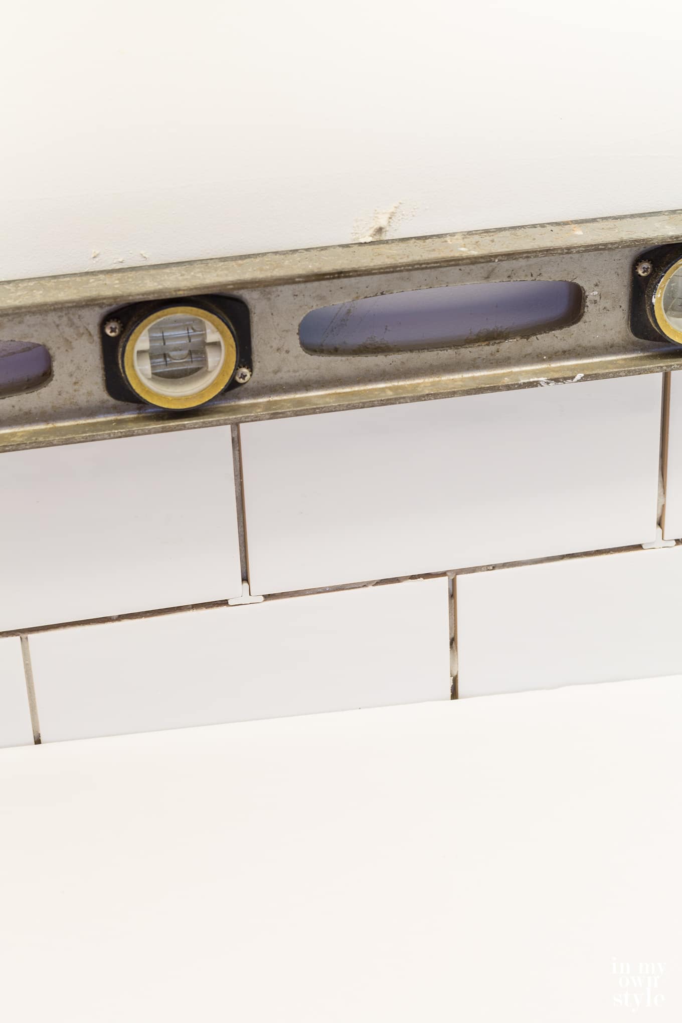 Subway tile installation on a kitchen backsplash