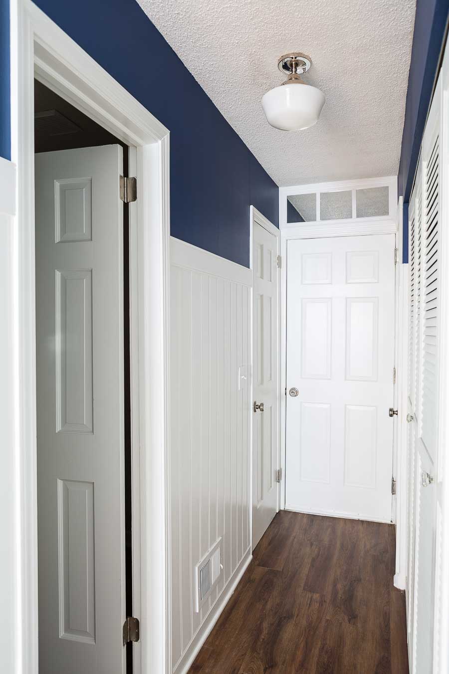  a fake transom made from a mirror and hung over a door that brightens a dark room.