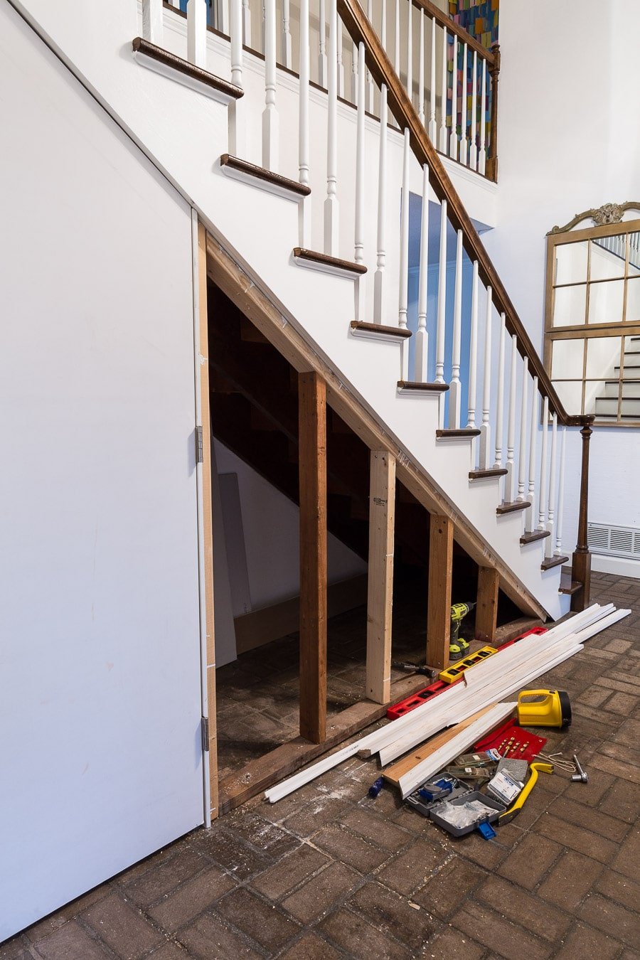 Tutorial showing how to DIY a closet under a staircase with a hidden door