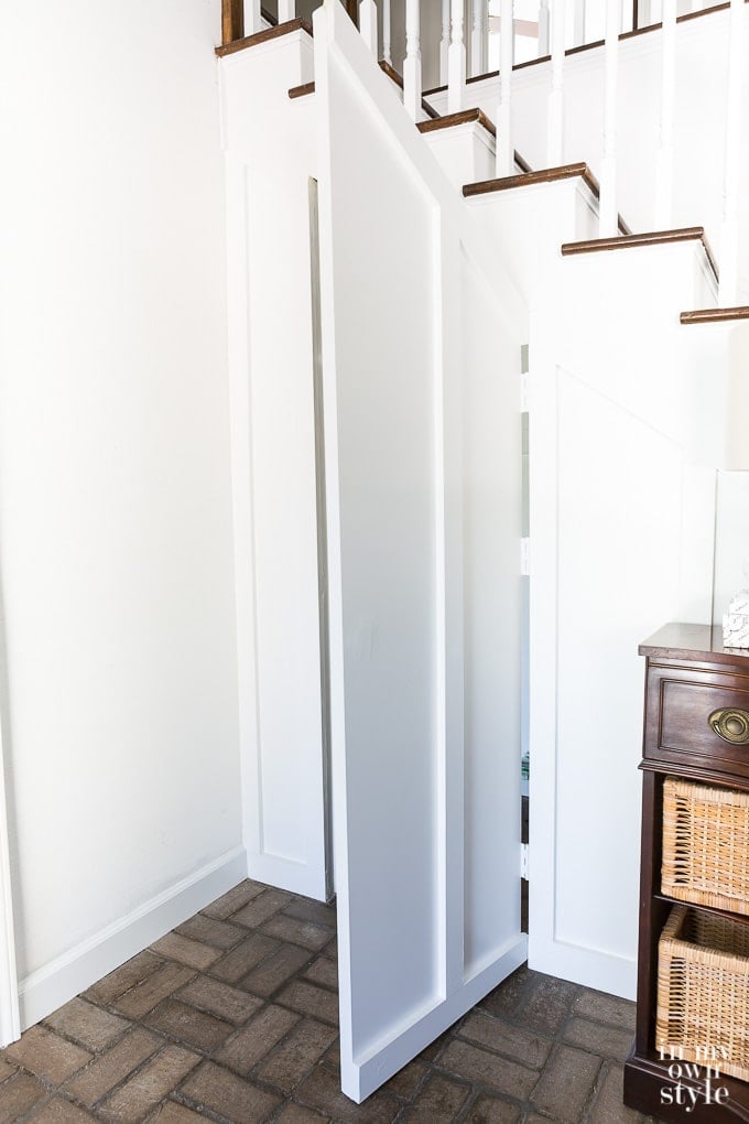 organizing storage in a closet under staircase