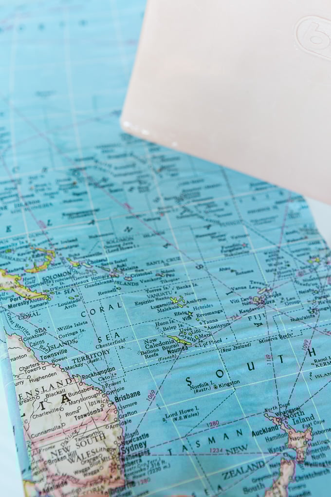 DIY map wallpaper step by step tutorial that shows how to remove wrinkles that may appear when applying maps and or paper to walls