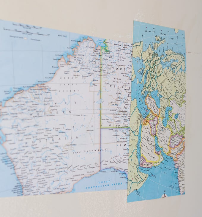 DIY map wallpaper step by step tutorial that shows how to remove wrinkles that may appear when applying maps and or paper to walls