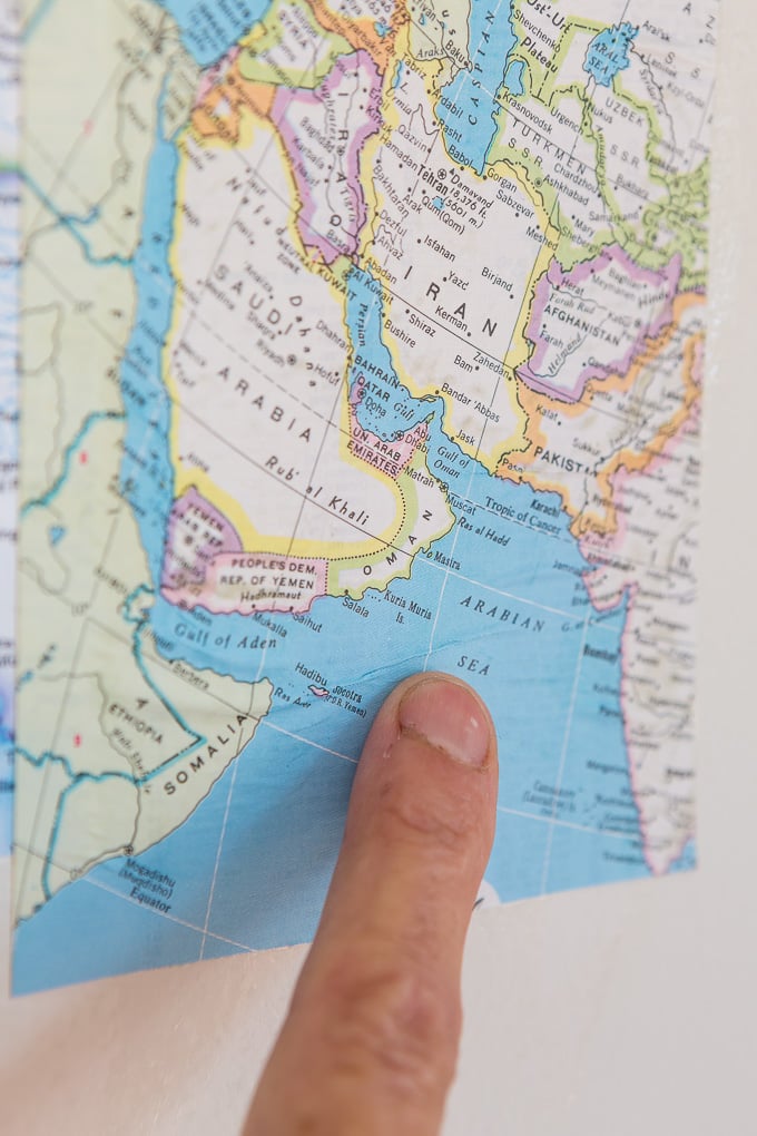 DIY map wallpaper step by step tutorial that shows how to remove wrinkles that may appear when applying maps and or paper to walls