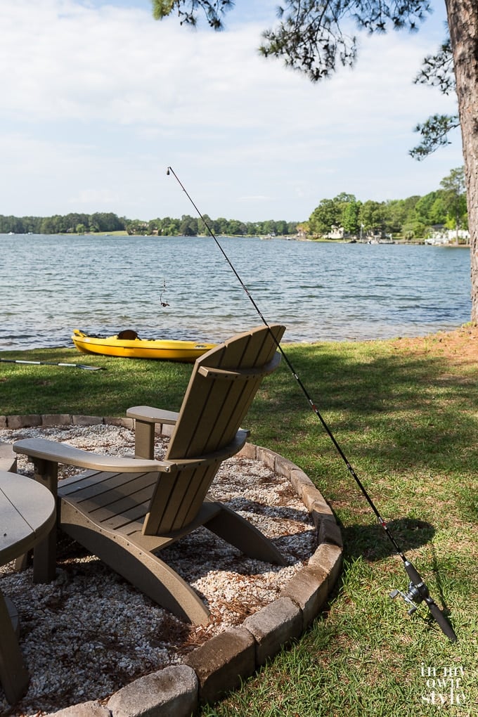 chair and fishing pole in yard along the shores of a lake