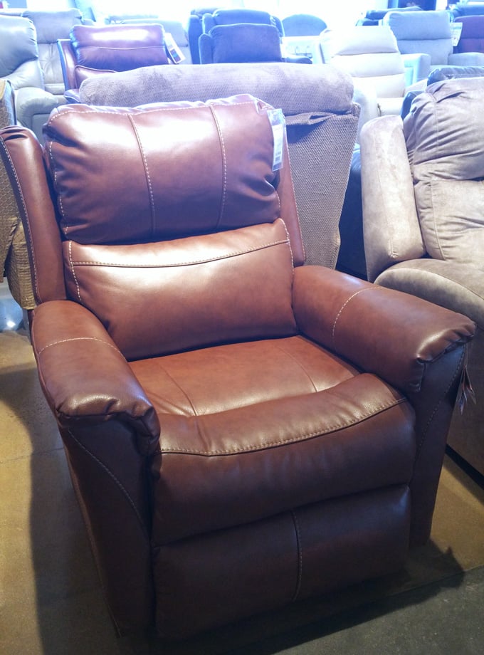 brown leather recliner in furniture showroom. 