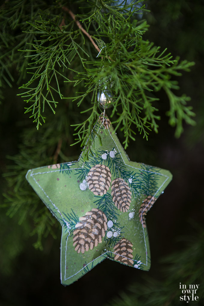Christmas star paper ornament to make using scrapbook paper. It gets ripped open on Christmas morning to find a small gift inside.