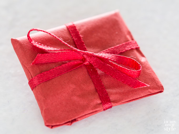 Gift wrapped package that goes into star ornament before being sewn closed.