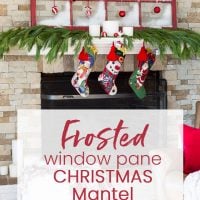 Christmas decorated mantel using an old red window sash and ornaments