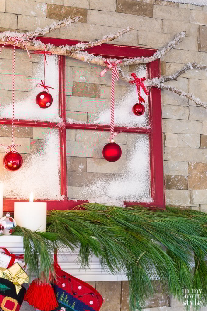 Christmas mantel decorating idea that uses an old window sash and tree branch.
