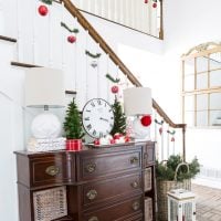 Christmas decorating ideas that are affordable, fast, and easy to do using garland ties. #Christmas #ChristmasDecorating #BudgetChristmas #ChristmasStaircase #HolidayFoyerDecor