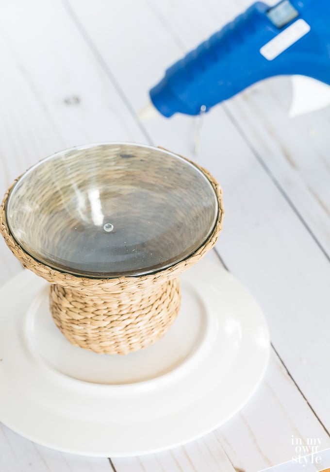 gluing a wicker candle holder and a white plate together