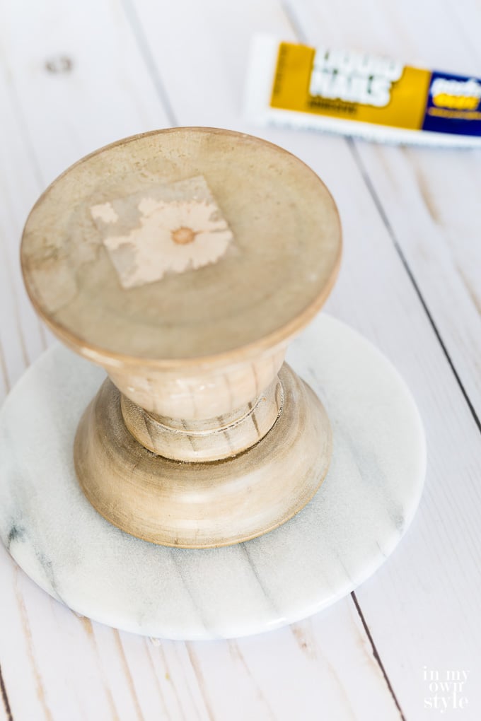 Gluing a wood pedestal and round marble top together.