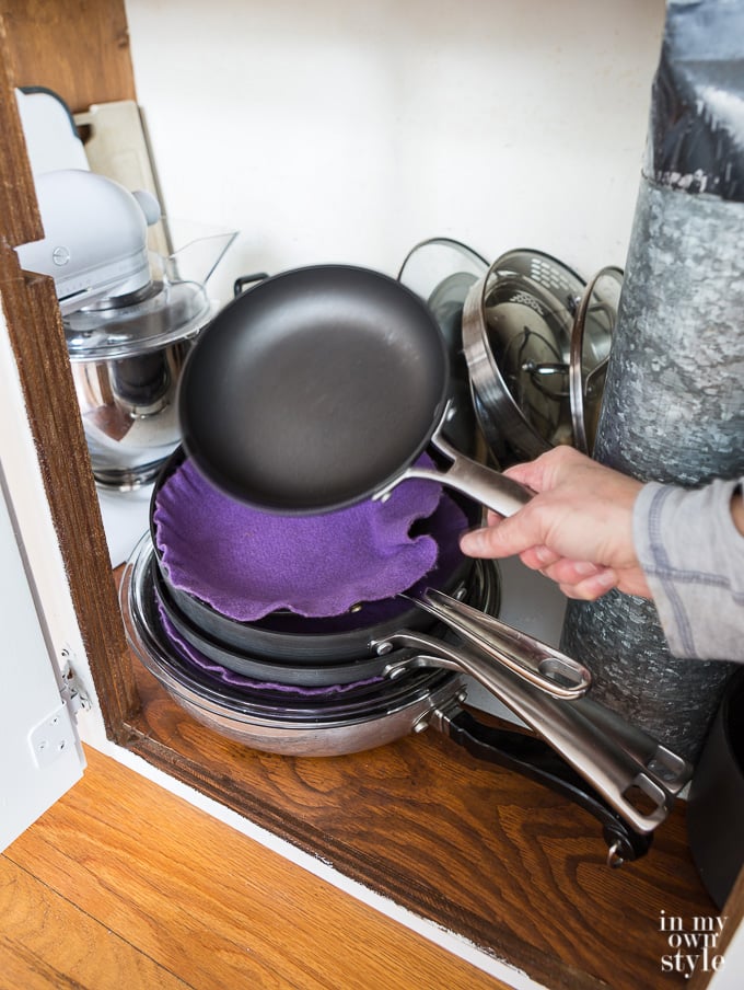 How to protect pots and pans from getting scratched when storing them in a kitchen cabinet.