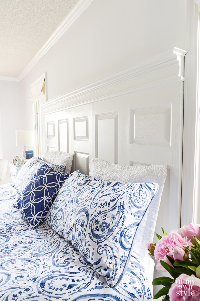 navy and white bedroom with bed headboard made using old doors
