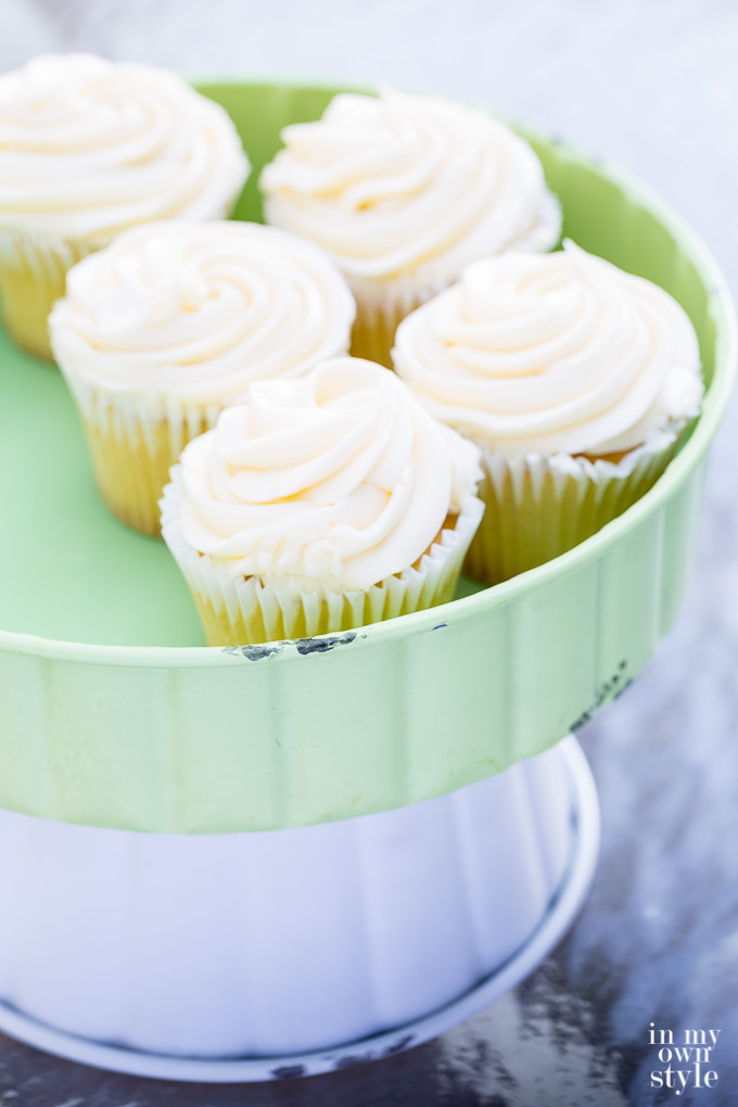 Vanilla cupcakes on pedestal server from the Trisha Yearwood Home Collection at Tractor Supply stores.