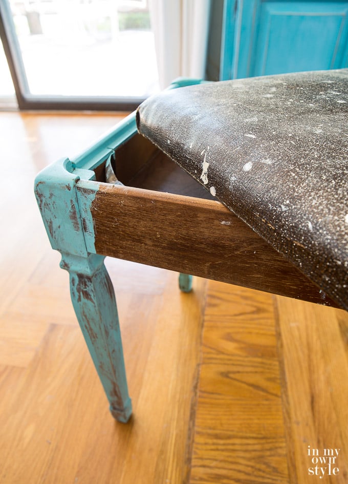 Stool before makeover showing top lifted off of it to show that you can store things inside.
