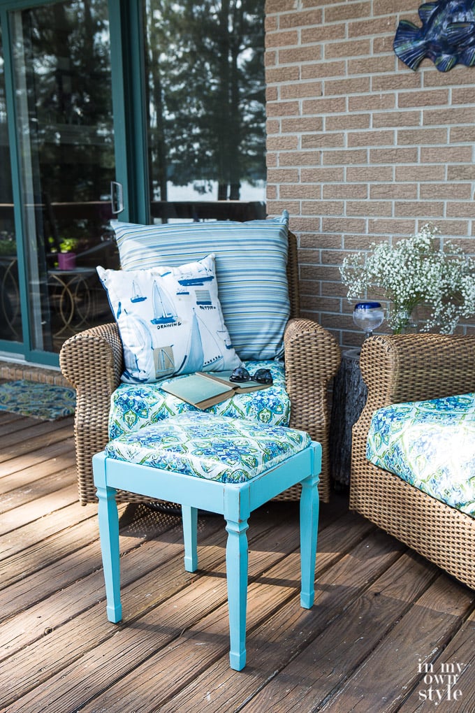 Completed painted small square stool with turquoise and green fabric and iron on clear lamination to protect from water.