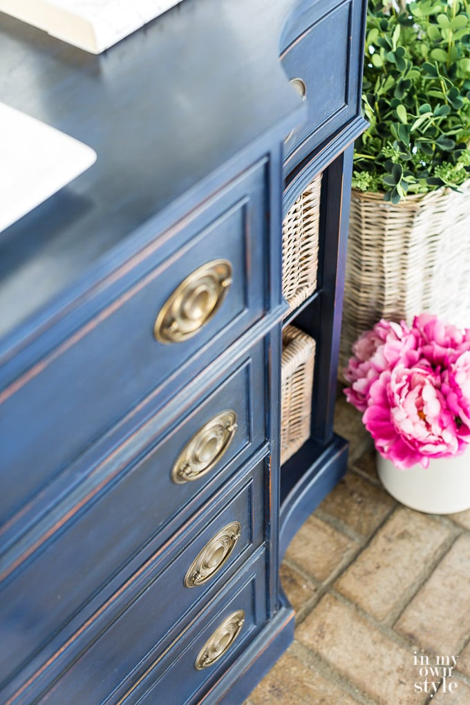 close up of a Brass and navy sideboard