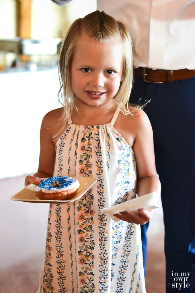 Little girleEating from a donut wedding cake at a wedding