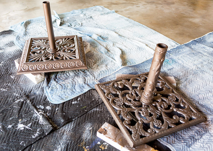 Two metal umbrella stands after being spray painted with Rustoleum Hammered spray paint.