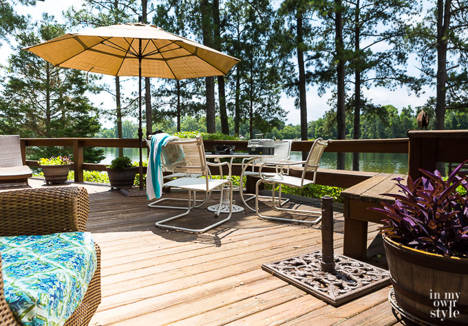 wood deck with umbrella in metal stand