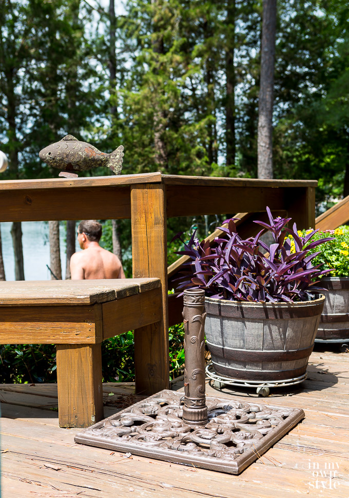 Newly spray painted outdoor umbrella stand on lakeside deck.