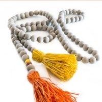 Fall wood bead garland with orange and yellow raffia tassels on the ends