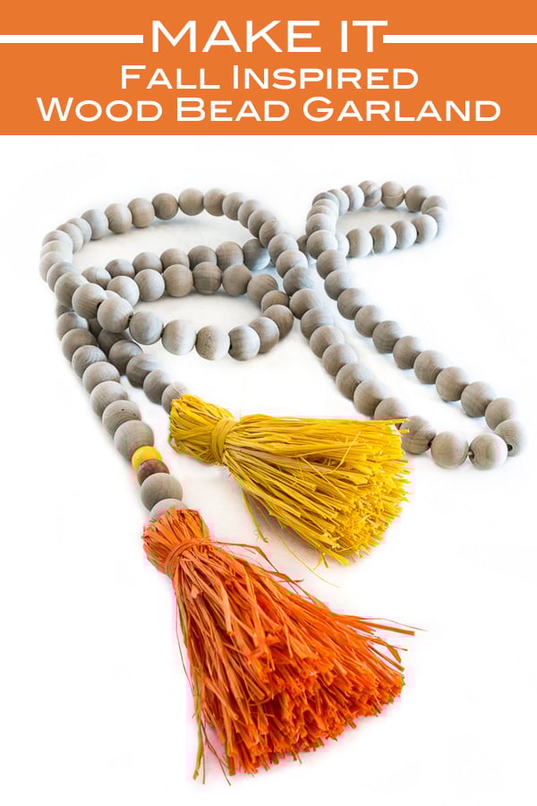Fall wood bead garland with orange and yellow raffia tassels on the ends