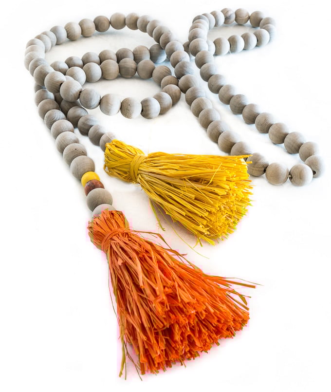 Driftwood stained wood bead garland with raffia tassels