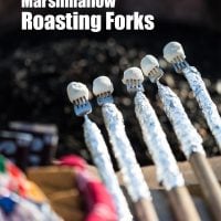 5 Roasting Forks over an outdoor firepit