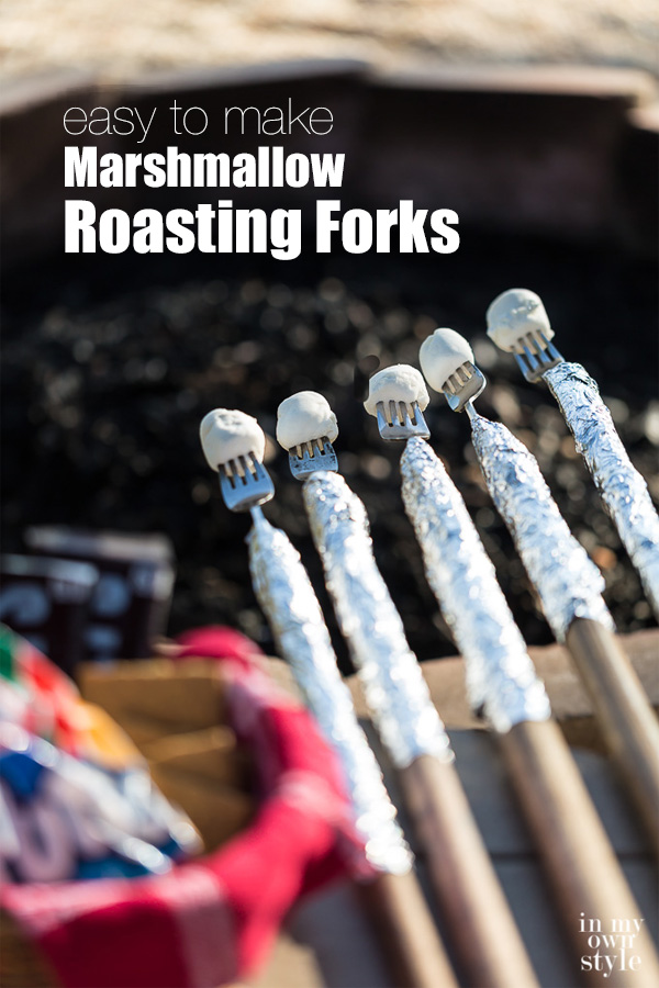 5 Roasting Forks over an outdoor firepit