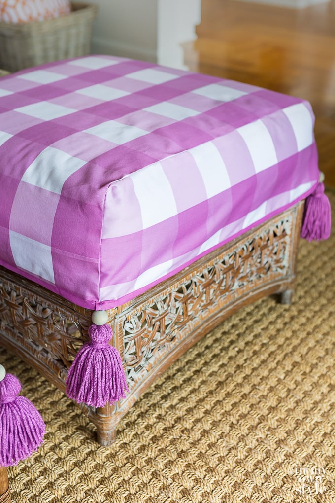Purple and white check ottoman cover with tassels