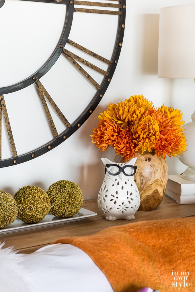 White owl candle holder and fall decor on sofa table