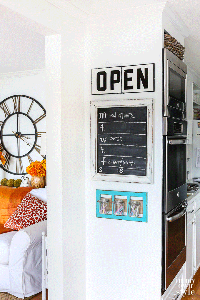 Black and white kitchen sign on wall that says open and closed