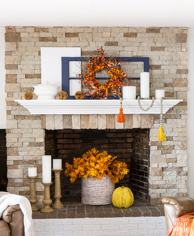White mantel decorated for fall.