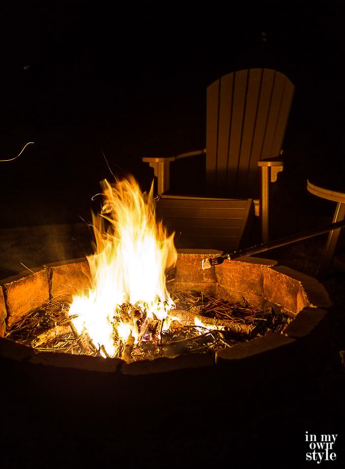 Outdoor fire pit ready to use marshmallow roasting sticks to make S'Mores