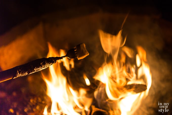Roasting a marshmallow at an outdoor firepit