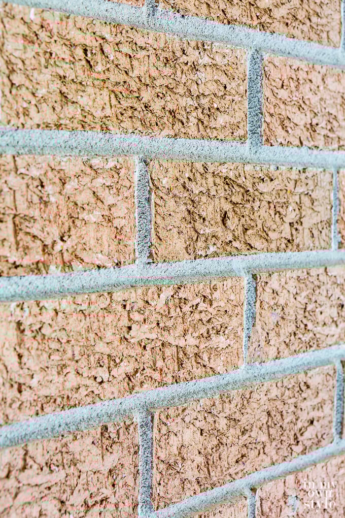 Textured rust red brick interior wall.